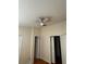 Bedroom with ceiling fan, wood floors, and multiple doors at 6023 Osprey Lake Cir, Riverview, FL 33578
