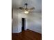 Empty bedroom with wood-look laminate floors, ceiling fan, and closet door at 6023 Osprey Lake Cir, Riverview, FL 33578