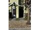 Front exterior of a two-story home with a brown door and green siding at 6023 Osprey Lake Cir, Riverview, FL 33578