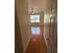 Hallway view of empty bedroom with laminate floors and ceiling fan at 6023 Osprey Lake Cir, Riverview, FL 33578