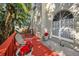 Red deck and patio furniture beside the house, surrounded by tropical plants at 609 S Glen Ave # B, Tampa, FL 33609