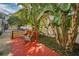 Red wood deck with two chairs and tropical plants at 609 S Glen Ave # B, Tampa, FL 33609