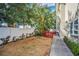 Backyard with grass, trees, a fence, and a small deck at 609 S Glen Ave # B, Tampa, FL 33609