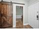 Entryway with rustic barn door and hardwood floors at 609 S Glen Ave # B, Tampa, FL 33609
