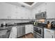 Modern kitchen with white cabinets, stainless steel appliances, and granite countertops at 609 S Glen Ave # B, Tampa, FL 33609
