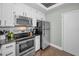 Modern kitchen with white cabinets, stainless steel appliances, and granite countertops at 609 S Glen Ave # B, Tampa, FL 33609