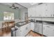 Modern kitchen with white cabinets, granite countertops, and breakfast bar at 609 S Glen Ave # B, Tampa, FL 33609