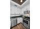 Modern kitchen with white cabinets, stainless steel appliances, and granite countertops at 609 S Glen Ave # B, Tampa, FL 33609