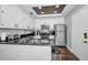 Modern kitchen with white cabinets, stainless steel appliances, and granite countertops at 609 S Glen Ave # B, Tampa, FL 33609
