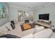 Living room with sectional sofa, TV, and hardwood floors at 609 S Glen Ave # B, Tampa, FL 33609