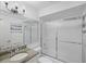 Bathroom with granite countertop, updated vanity, and a frosted glass shower at 705 Loma Linda Ct, Brandon, FL 33511