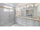 Double vanity bathroom with granite countertop and large mirror at 705 Loma Linda Ct, Brandon, FL 33511