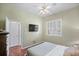 Bedroom with wood floors, a ceiling fan, and a view of the backyard at 705 Loma Linda Ct, Brandon, FL 33511