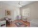 Well-lit bedroom with hardwood floors and white wicker furniture at 705 Loma Linda Ct, Brandon, FL 33511