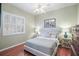 Bright bedroom with wood floors, a ceiling fan, and a window with shutters at 705 Loma Linda Ct, Brandon, FL 33511