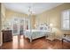 Spacious bedroom with hardwood floors, French doors, and a post bed at 705 Loma Linda Ct, Brandon, FL 33511