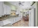 Modern kitchen with white cabinets, granite countertops, and tiled floor at 705 Loma Linda Ct, Brandon, FL 33511