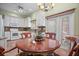 Bright kitchen with granite countertops, white cabinets, and a breakfast nook at 705 Loma Linda Ct, Brandon, FL 33511