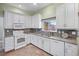 Well-equipped kitchen featuring white cabinets and granite countertops at 705 Loma Linda Ct, Brandon, FL 33511