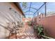 Screened patio with terracotta tile flooring and wicker chairs at 705 Loma Linda Ct, Brandon, FL 33511