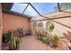 Screened patio with terracotta tile flooring and lush greenery at 705 Loma Linda Ct, Brandon, FL 33511