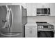 Stainless steel appliances and white cabinets in this kitchen at 7233 56Th N Ave, St Petersburg, FL 33709