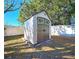 Backyard shed nestled amongst trees at 7521 Coventry Dr, Port Richey, FL 34668