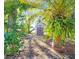 Tropical backyard with shed partially visible at 7521 Coventry Dr, Port Richey, FL 34668