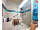 Walk-in shower with bench and nautical theme at 7521 Coventry Dr, Port Richey, FL 34668