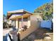 View of side of house with white fence and two trash bins at 7521 Coventry Dr, Port Richey, FL 34668