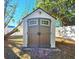 White and brown storage shed with double doors at 7521 Coventry Dr, Port Richey, FL 34668