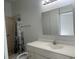 Clean bathroom with vanity, shower, and mirror at 8601 Twin Lakes Blvd, Tampa, FL 33614