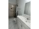 Updated bathroom with walk-in shower and vanity at 8601 Twin Lakes Blvd, Tampa, FL 33614