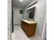 Updated bathroom with new vanity, tile flooring, and a shower/tub combo at 8601 Twin Lakes Blvd, Tampa, FL 33614