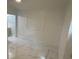 Spacious bedroom with marble-look floors and lots of natural light at 8601 Twin Lakes Blvd, Tampa, FL 33614