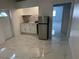 Clean and modern kitchen with white cabinets and marble-look floors at 8601 Twin Lakes Blvd, Tampa, FL 33614