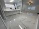 Modern kitchen boasting white cabinets, a large island, and marble-look floors at 8601 Twin Lakes Blvd, Tampa, FL 33614