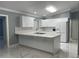 Modern kitchen featuring white cabinets, quartz countertops, and stainless steel appliances at 8601 Twin Lakes Blvd, Tampa, FL 33614