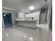 Modern kitchen with white cabinets, quartz countertops, and marble-look floors at 8601 Twin Lakes Blvd, Tampa, FL 33614