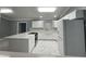 Modern kitchen with white cabinets, a large island, and marble-look floors at 8601 Twin Lakes Blvd, Tampa, FL 33614