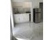 Well-appointed galley kitchen with white cabinets and marble-look flooring at 8601 Twin Lakes Blvd, Tampa, FL 33614