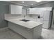 Modern kitchen with white cabinets, quartz countertops and stainless steel appliances at 8601 Twin Lakes Blvd, Tampa, FL 33614