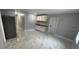 Modern kitchenette features white cabinets and marble-look flooring at 8601 Twin Lakes Blvd, Tampa, FL 33614