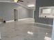 Open living area with marble-look floors and kitchen view at 8601 Twin Lakes Blvd, Tampa, FL 33614