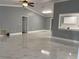 Spacious living room featuring high ceilings, ceiling fan, and marble-look flooring at 8601 Twin Lakes Blvd, Tampa, FL 33614