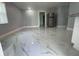 Bright living room with marble-look floors and stainless steel refrigerator at 8601 Twin Lakes Blvd, Tampa, FL 33614