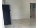 Bright living room with marble-look floors and access to the kitchen and bathroom at 8601 Twin Lakes Blvd, Tampa, FL 33614