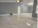 Bright and airy living room with high ceilings, ceiling fan and marble-look flooring at 8601 Twin Lakes Blvd, Tampa, FL 33614