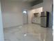 Spacious living area with marble-look flooring and a kitchenette at 8601 Twin Lakes Blvd, Tampa, FL 33614