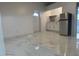 Bright living room with marble-look floors and access to kitchen and exterior at 8601 Twin Lakes Blvd, Tampa, FL 33614